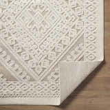 Close-up of the Hibah Bone Area Rug showing its geometric pattern, neutral beige tones, and textured weave. Fold