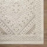Close-up of the Hibah Bone Area Rug showing its contemporary geometric design and textured beige and bone color palette. Corner