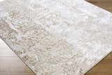 Close-up of the Junko Area Rug, a contemporary rug in beige, cream, and tan, with a subtle abstract pattern. Corner