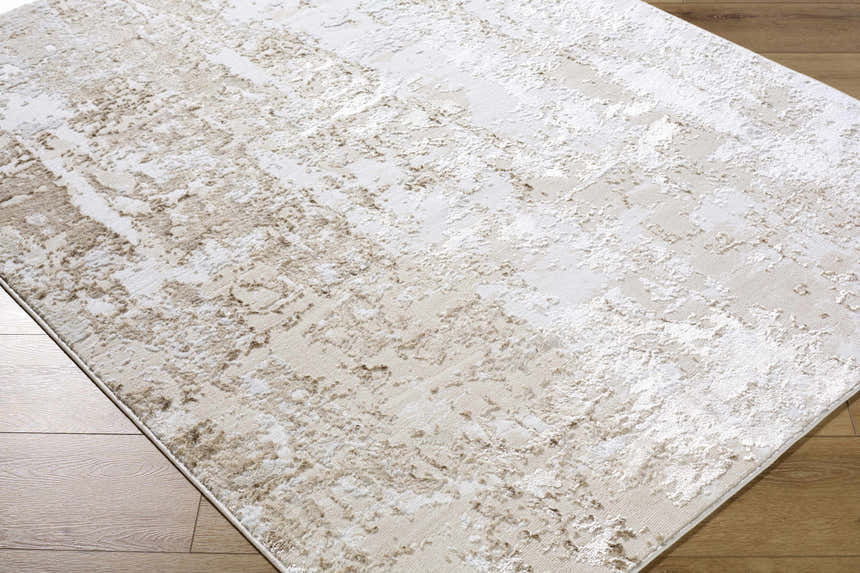 Close-up of the Junko Area Rug, a contemporary rug in beige, cream, and tan, with a subtle abstract pattern. Corner