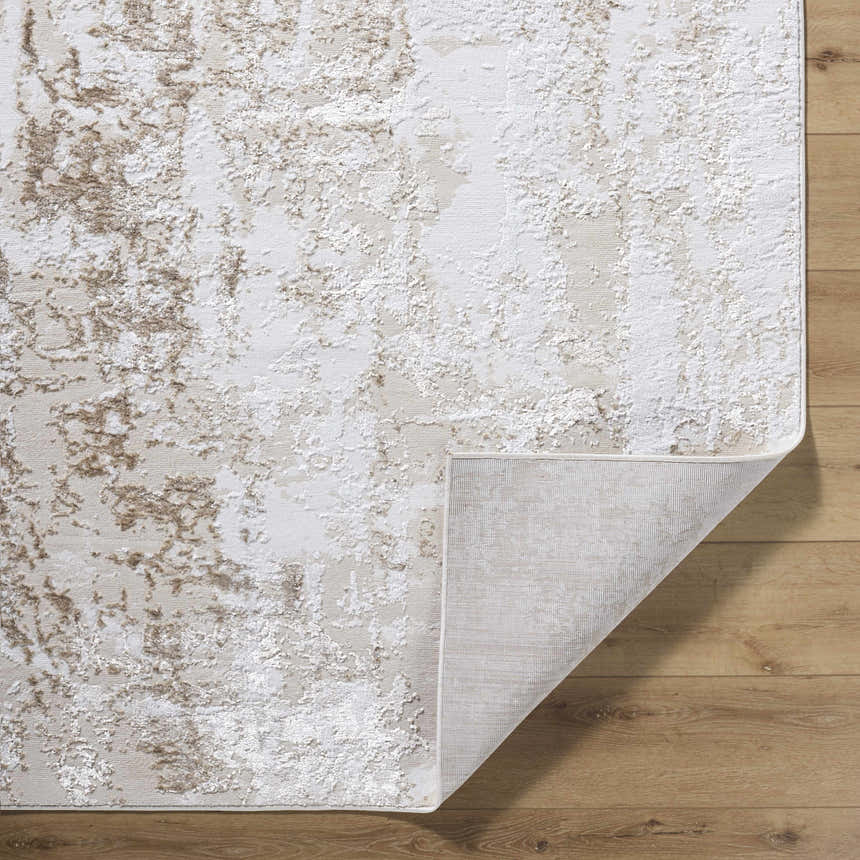 Close-up of the Junko Area Rug showing its beige, cream, and tan abstract design and machine-woven texture. Fold