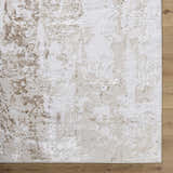 Close-up of the Junko Area Rug, a contemporary rug in beige, cream, and tan with a textured, abstract pattern. Corner