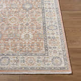 Close-up of the Adilet Dark Pink Washable Area Rug showing its traditional pattern, pink, gray, and cream colors, and woven texture. Front