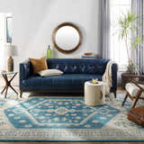 Living room scene with a blue leather sofa and the aqua Stepps Area Rug. Roomscene-Rectangle