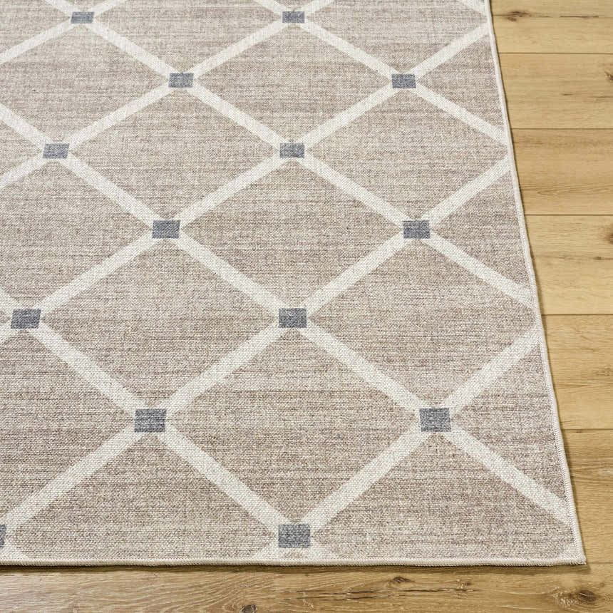 Close up of the Alpana Washable Wool Area Rug. Beige rug with ivory diamond pattern and slate gray accents on wood floor. Front