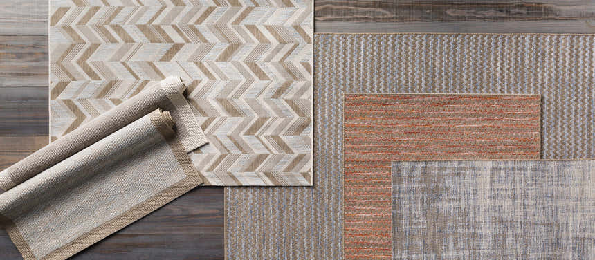 Close-up of Escalon Area Rug - Clearance. Cream, taupe, and orange rugs with contemporary striped and chevron patterns. Styleshot