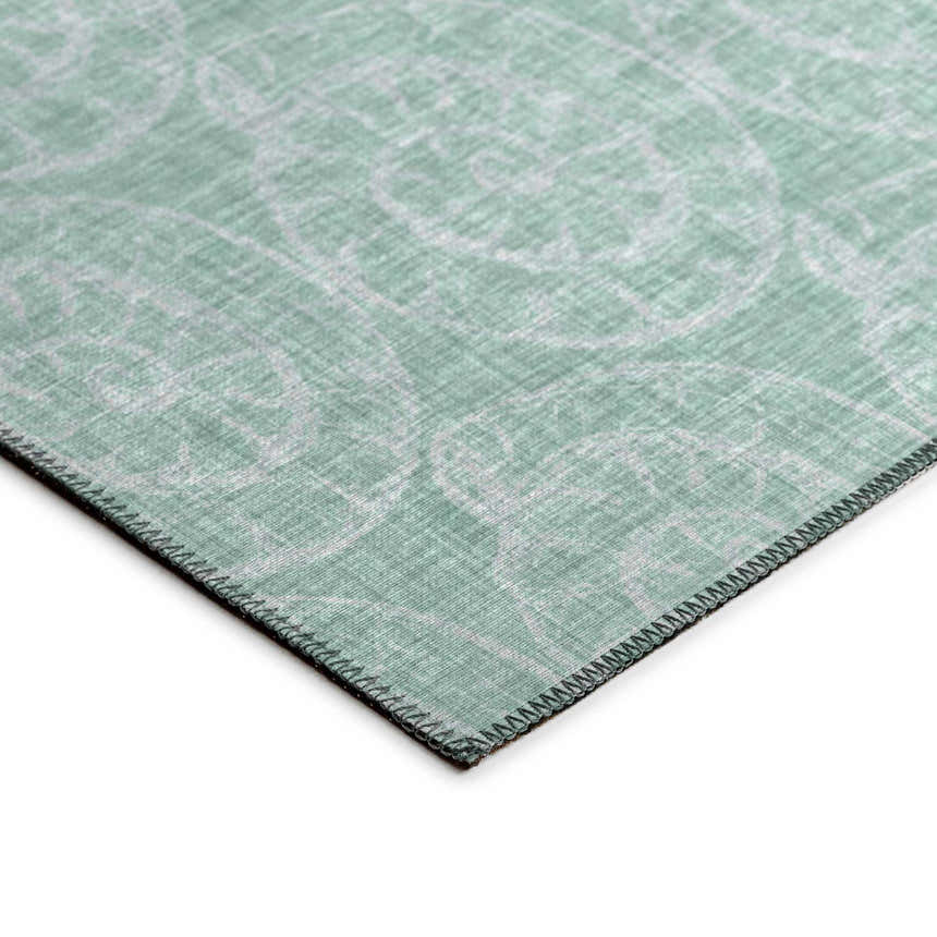 Close-up of Dalyn Seabreeze SZ11 Sage Washable Area Rug. Muted sage rug with a subtle chestnut and charcoal floral pattern.