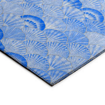 Close-up of Dalyn Seabreeze Navy Washable Area Rug featuring a blue fan pattern and stitched edge detail.