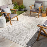 Outdoor patio scene with gray chairs and a light peach and white Tabuan 3D Outdoor Area Rug. Roomscene-Rectangle