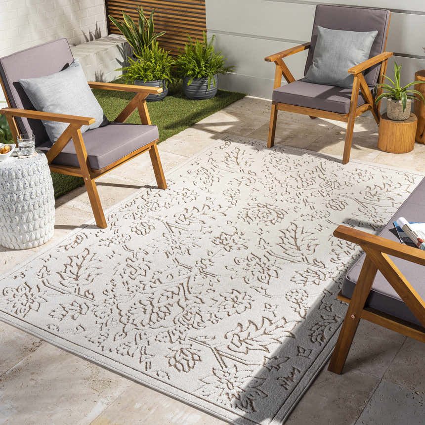 Outdoor patio scene with gray chairs and a light peach and white Tabuan 3D Outdoor Area Rug. Roomscene-Rectangle