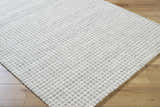 Close-up of Andreas Handmade Vivir x LIVABLISS VVAN-2302 Area Rug. Ash, dove gray, and ivory wool with a textured grid pattern. Corner