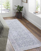 Living room scene with beige Lorelai runner rug, wood floors, gray sofa, and natural light from the window. Roomscene-Runner