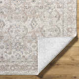 Close-up of the Tyren Area Rug showing its cream, light slate, sage, slate blue, and tan traditional pattern and textured weave. Fold