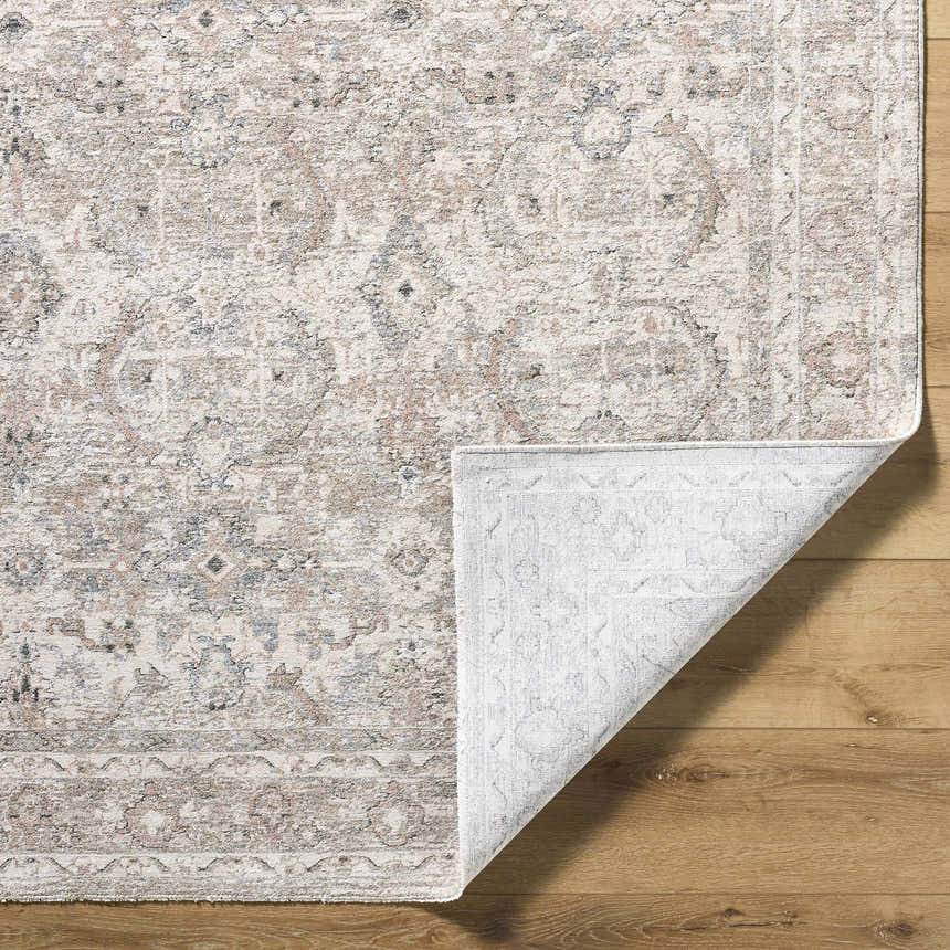 Close-up of the Tyren Area Rug showing its cream, light slate, sage, slate blue, and tan traditional pattern and textured weave. Fold