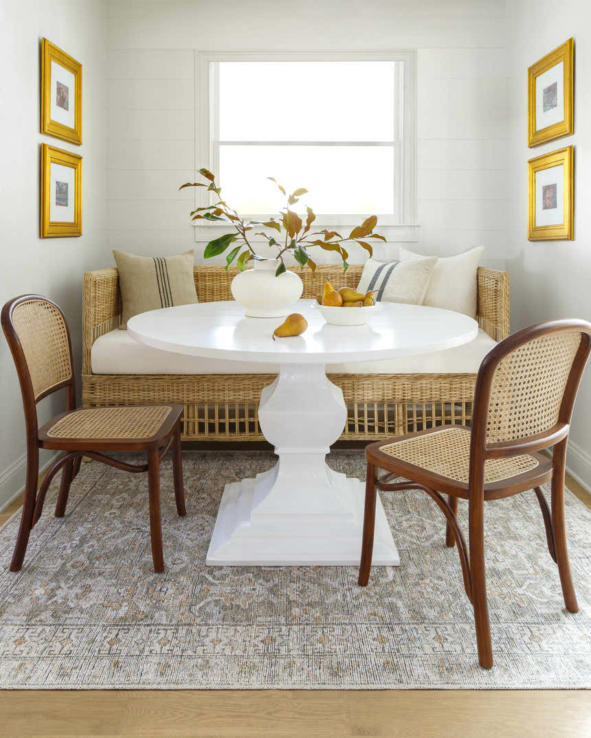 Dining nook with a white table and the tan, gray Tisha Washable Area Rug. Farmhouse style. Roomscene-Rectangle
