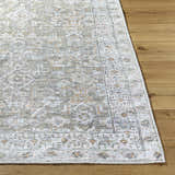 Close-up of Tisha Washable Area Rug showing its traditional gray, tan, and silver pattern and machine-woven texture. Front