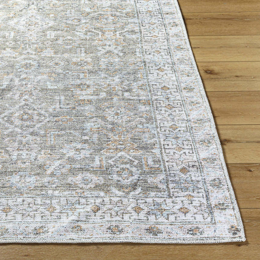 Close-up of Tisha Washable Area Rug showing its traditional gray, tan, and silver pattern and machine-woven texture. Front