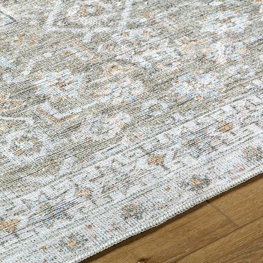 Close-up of the Tisha Washable Area Rug. Traditional gray, light silver, and tan pattern on a soft polyester rug. Texture
