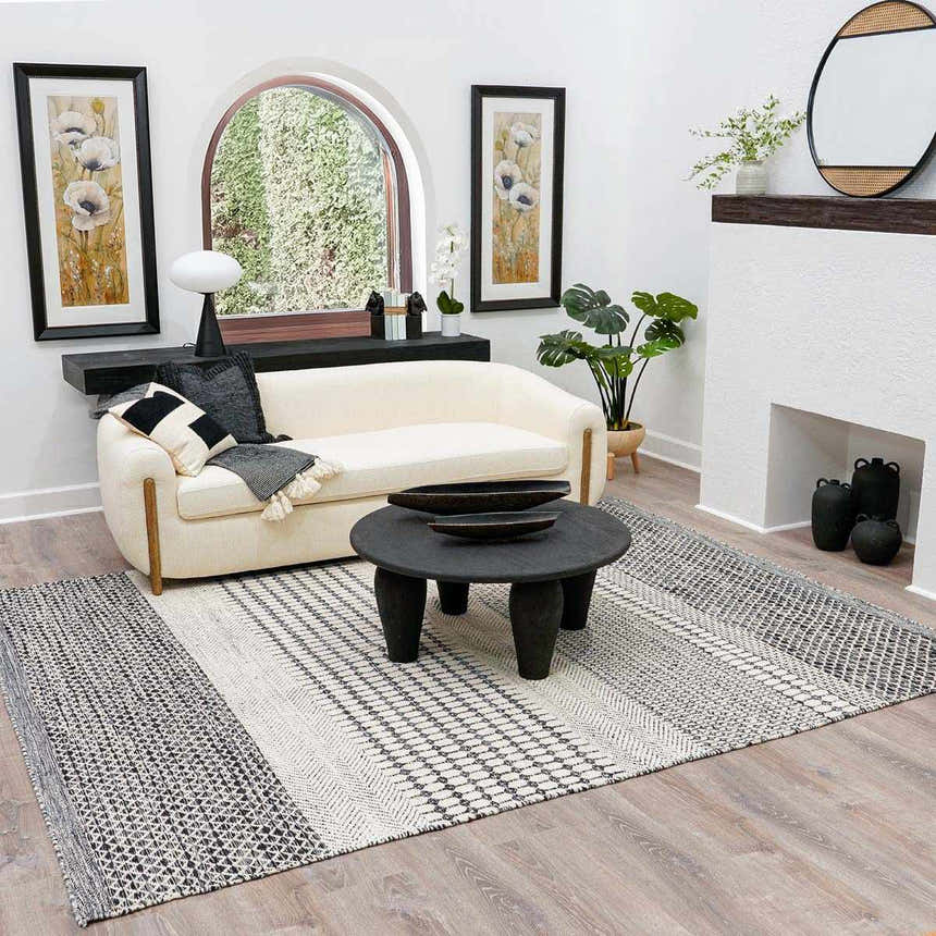 Living room scene with a Tideswell Scandi Boho Wool Carpet, cream sofa, black coffee table, and neutral decor. Roomscene-Rectangle