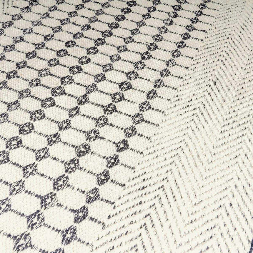 Close-up of the Tideswell Scandi Boho Wool Carpet showing its beige wool texture and black geometric and chevron patterns. Texture
