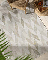 Close-up of Andrea Ivory Area Rug featuring a geometric diamond pattern in ivory, sage, sandstone, and sky blue hues. Roomscene-Rectangle