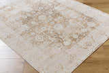 Close-up of the Aniyah Washable Area Rug. Colors are ash, pearl, prairie dust, and tan with a traditional pattern. Corner