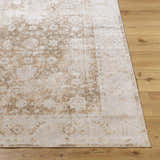 Close-up of the Aniyah Washable Area Rug in ash, pearl, and tan on a wood floor. Traditional farmhouse style. Front