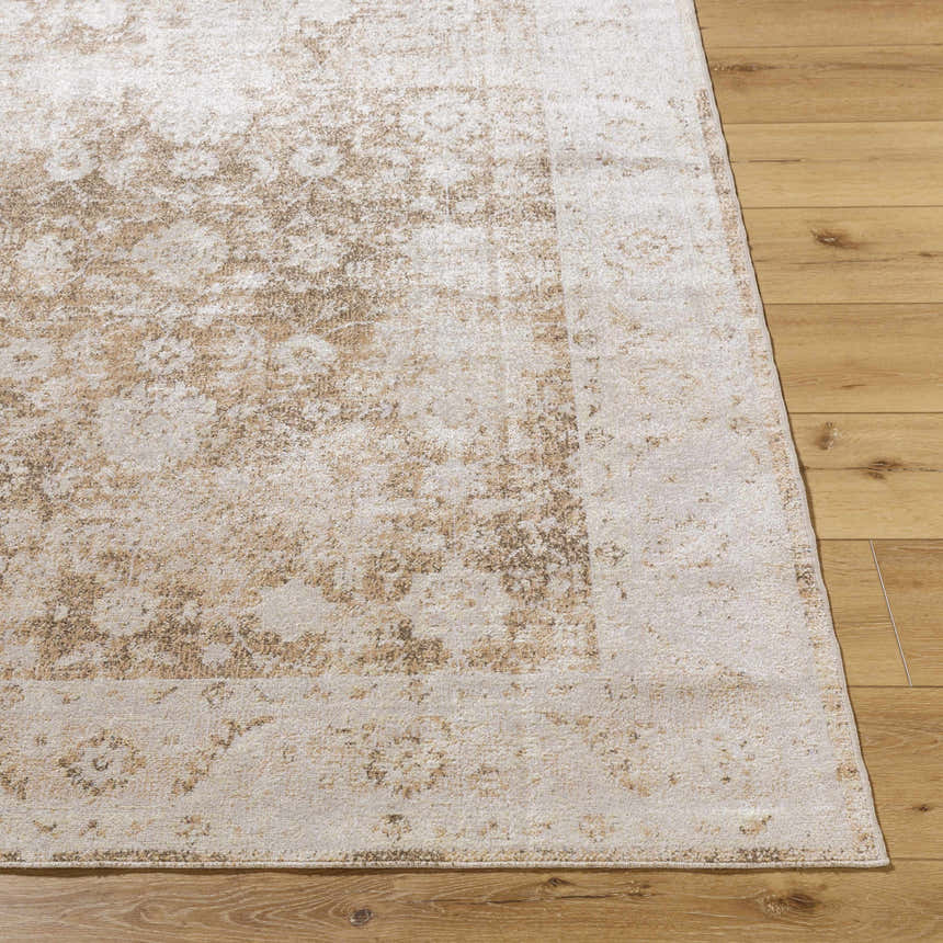 Close-up of the Aniyah Washable Area Rug in ash, pearl, and tan on a wood floor. Traditional farmhouse style. Front
