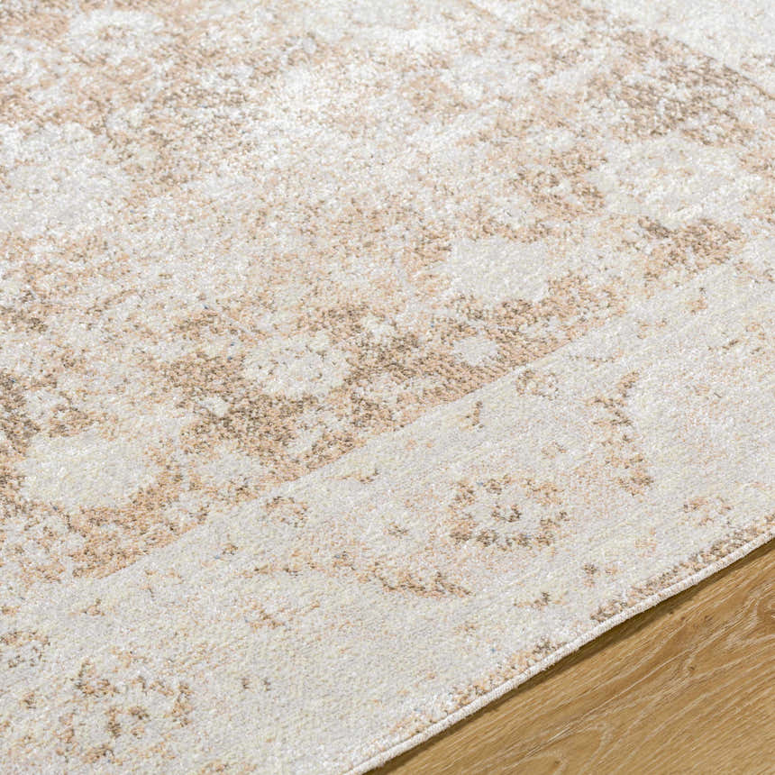 Close-up of the Aniyah Washable Area Rug, showing its ash, pearl, and tan farmhouse pattern and soft texture. Texture