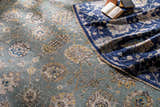 Close-up of the hand-knotted Toquerville Premium Rug in aqua, charcoal, oatmeal, and wheat, with a traditional floral pattern. Styleshot