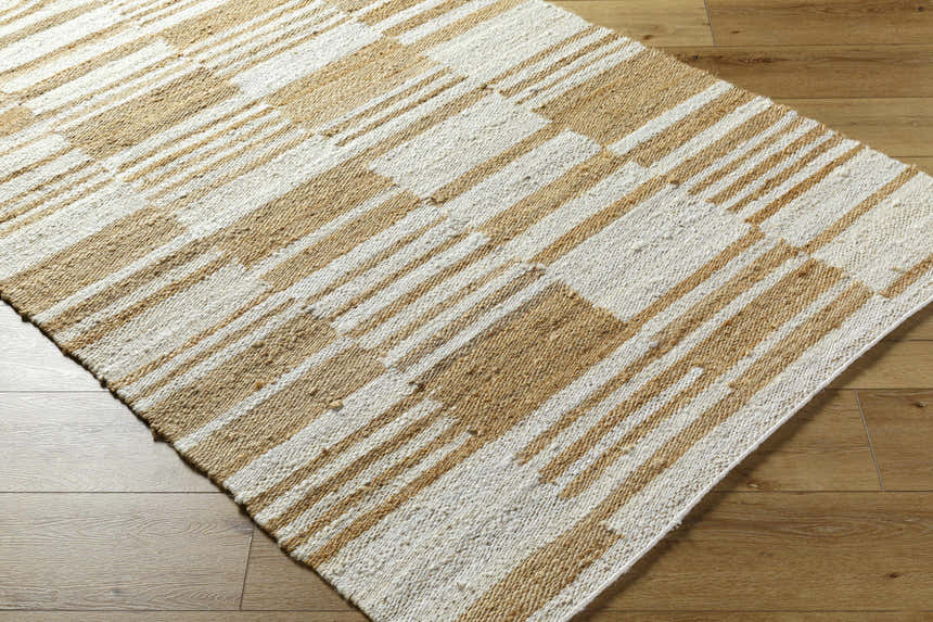 Close up of Kamey Handmade Becki Owens x LIVABLISS BOKY-2307 Area Rug. Jute rug with ivory, sandstone, and yellow stripes. Corner