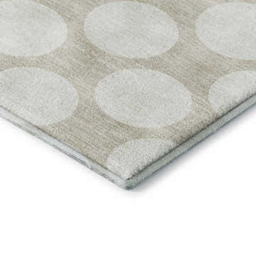 Close-up of Dalyn Luxury The Reserve TR13 beige washable rug with a geometric pattern of large white circles.