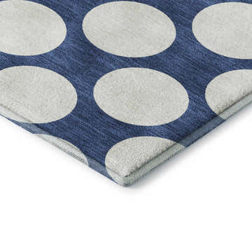 Close-up of Dalyn Luxury The Reserve TR13 Navy Washable Area Rug with a large white polka dot geometric pattern.