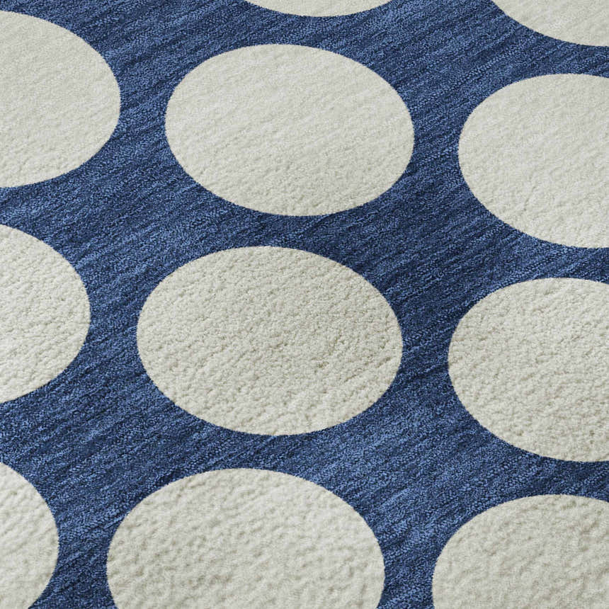 Close-up of Dalyn Luxury The Reserve TR13 Navy Washable Area Rug. Features a navy background with large white polka dots.