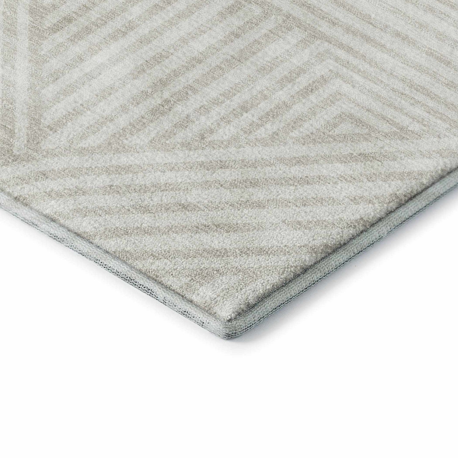 Close-up of Dalyn Luxury The Reserve TR14 Linen Washable Area Rug. Beige rug with a geometric pattern and soft texture.