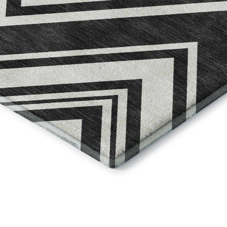 Close-up of Dalyn Luxury The Reserve TR17 Black Washable Area Rug with a bold black and off-white geometric pattern.