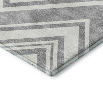 Close-up of Dalyn Luxury The Reserve TR17 Pewter Washable Area Rug with a geometric pattern in medium gray and light gray.
