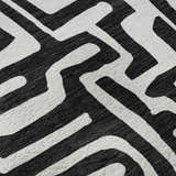 Close up of Dalyn Luxury The Reserve TR1 Black Washable Area Rug. Black and white geometric pattern.