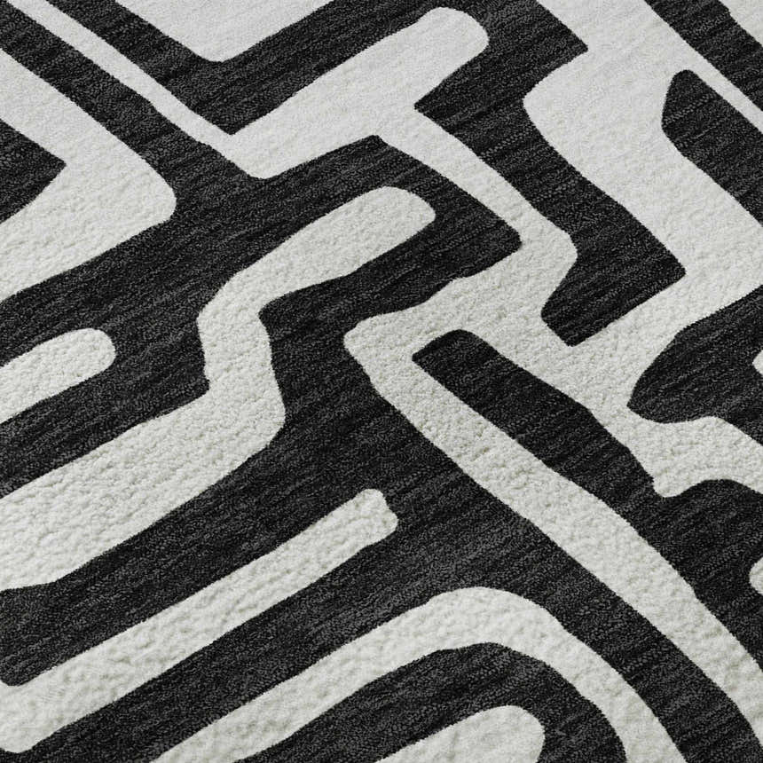 Close up of Dalyn Luxury The Reserve TR1 Black Washable Area Rug. Black and white geometric pattern.