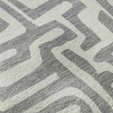 Close-up of the Dalyn Luxury The Reserve TR1 Gray Washable Area Rug featuring a geometric pattern in gray and taupe.