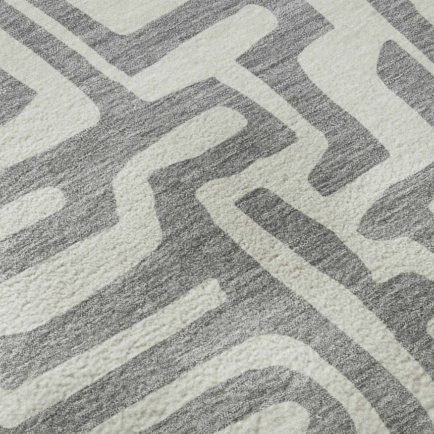 Close-up of the Dalyn Luxury The Reserve TR1 Gray Washable Area Rug featuring a geometric pattern in gray and taupe.