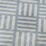 Close-up of Dalyn Luxury The Reserve TR3 Denim Washable Area Rug, showing geometric pattern in denim and white.