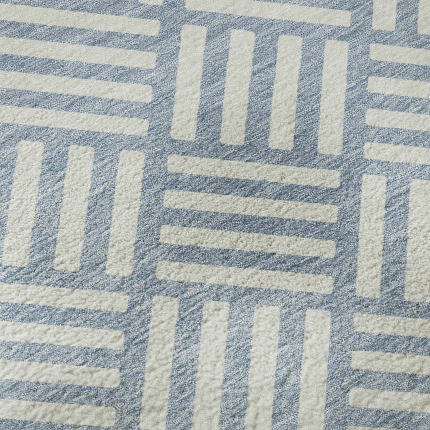 Close-up of Dalyn Luxury The Reserve TR3 Denim Washable Area Rug, showing geometric pattern in denim and white.