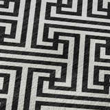 Close-up of the Dalyn Luxury The Reserve TR5 Black Washable Area Rug featuring a geometric black and white pattern.