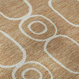 Close-up of Dalyn Luxury The Reserve TR6 Copper Washable Area Rug. Caramel rug with white geometric circle pattern.