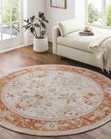 Sunlit living room with round Tsawwassen Thick Luxe Area Rug in brick red, beige, and charcoal under a daybed. Roomscene-Round