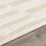 Close-up of the hand-tufted Teige Light Silver Area Rug. Wool rug with geometric pattern in light silver and sterling gray. Pile