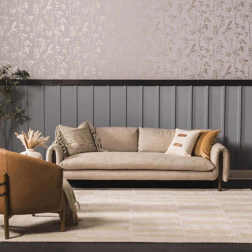 Living room scene with a Teige Light Silver Area Rug, beige sofa, and patterned wallpaper. Roomscene-Rectangle