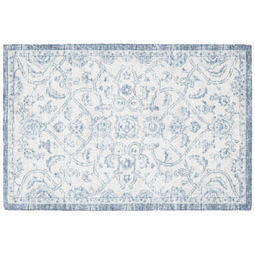 Close-up of the Dalyn Indoor/Outdoor Tuscany TU8 Denim Area Rug featuring a traditional floral pattern in denim blue and beige.
