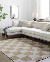Living room with a Becki Owens x LIVABLISS BOKY-2302 area rug in a light brown and white checkerboard pattern under a cream sectional. Roomscene-Rectangle